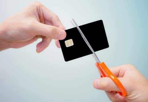 Scissors cutting through a credit card